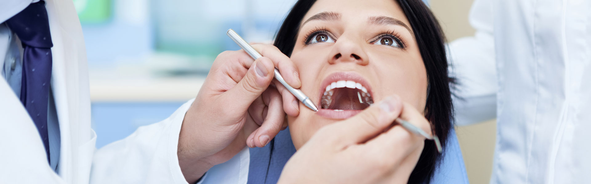 A Dentist examining patient teeth