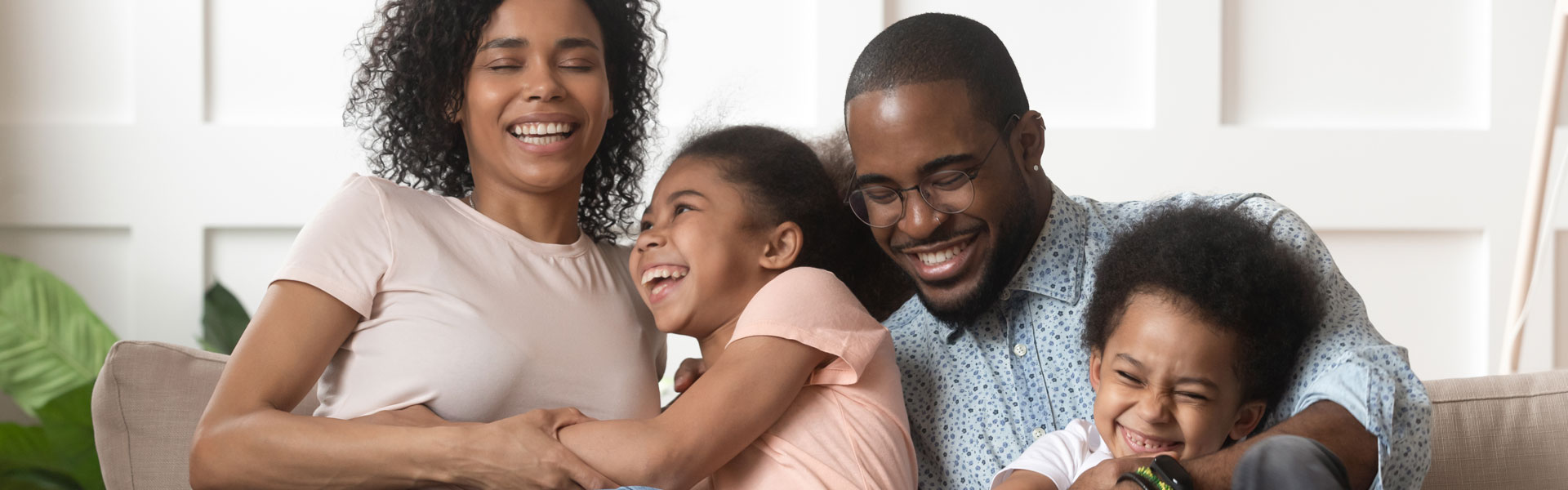 Happy african american family sitting on couch