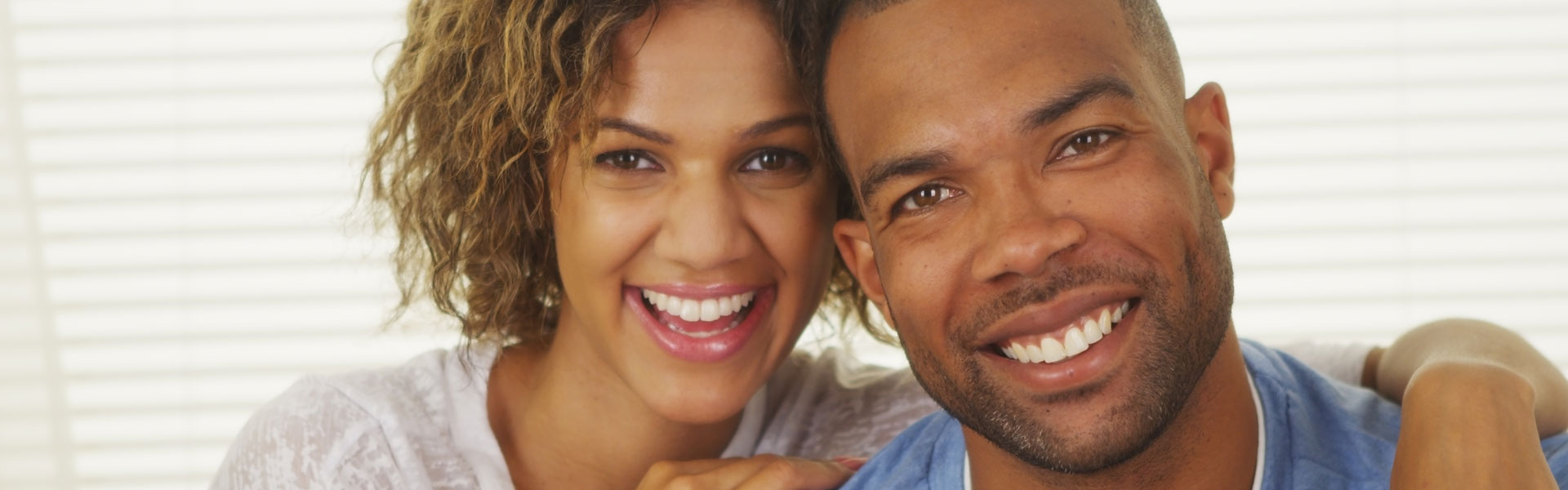 Happy african american couple after having dental crowns