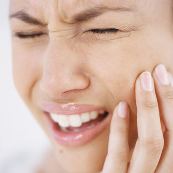 Woman suffering from jaw pain