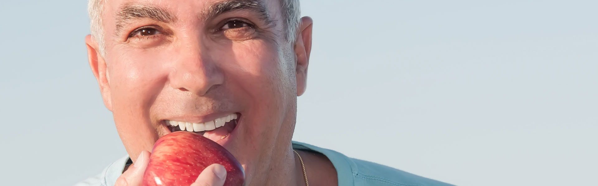 Senior male biting an apple