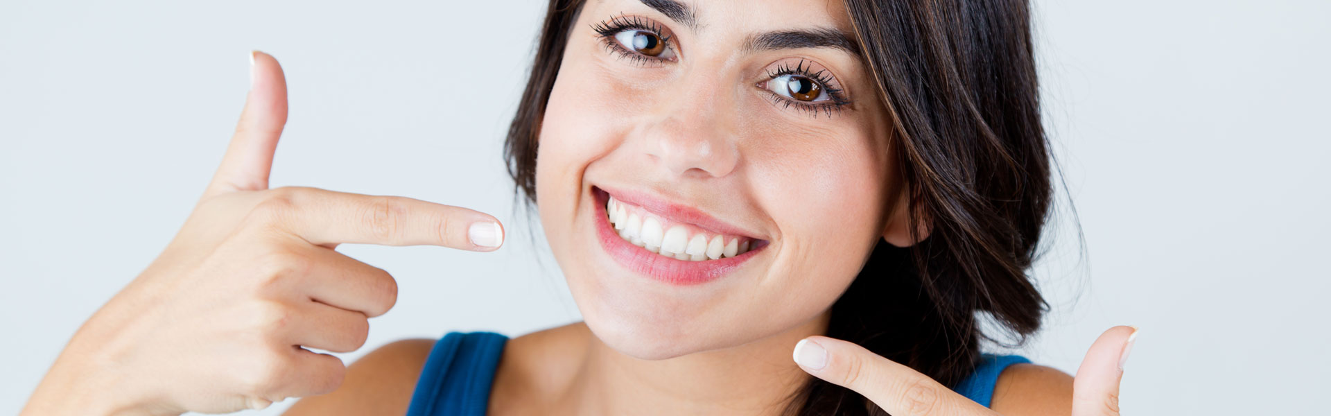 Woman pointing at her teeth